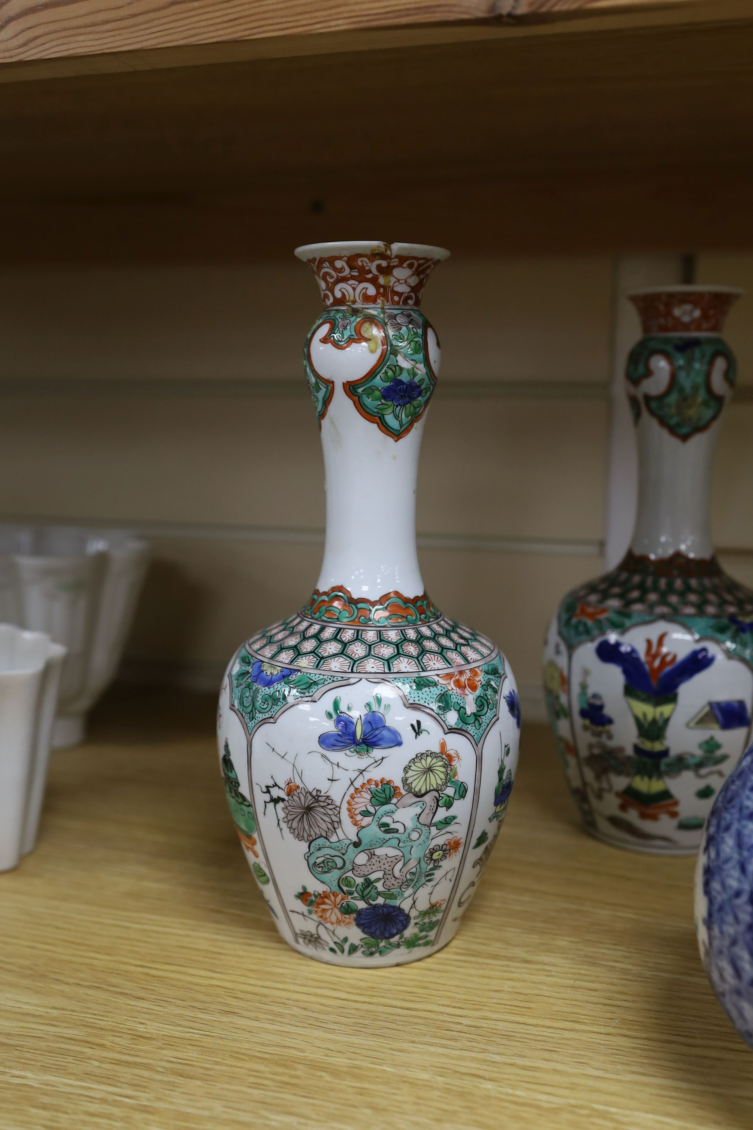 A pair Samson of Paris vases in the Chinese famille verte style and a Chinese Qianlong famille rose garlic neck vase with blue panelling motif, tallest 26cm